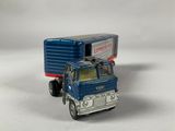 a toy truck with a trailer on the back of it