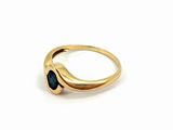 a close up of a gold ring with a blue stone