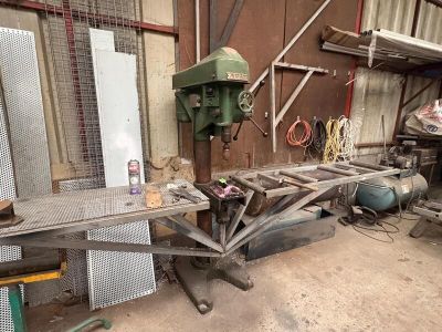 a picture of a workbench in a workshop with a lot of tools on it