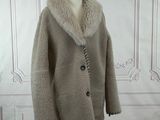 an image of a coat on a mannequin stand