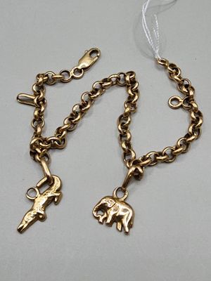 an image of a gold chain bracelet with two charms on it