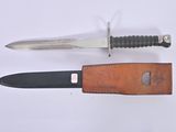 a knife that is laying next to a leather sheath