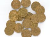 a lot of coins that are on a white surface