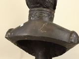 an old bronze bust of a man with a beard on a pedestal