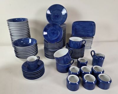 a lot of blue and white dishes and cups on the table