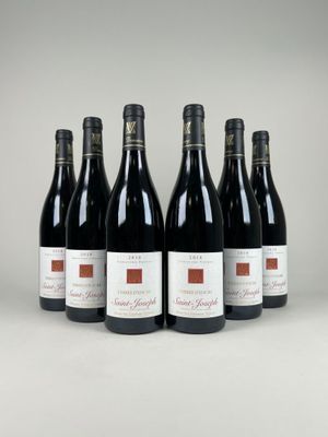 six bottles of red wine lined up in a row