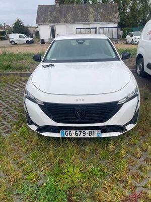 a white car that is parked in the grass