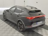 the rear end of a gray car parked in a garage