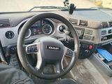 dashboard view of a vehicle with a steering wheel and dashboard controls