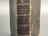 an old book sitting on top of a black table