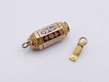 a small gold object with a blue design on it