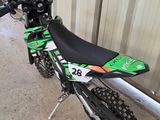 a dirt bike that is parked in front of a building
