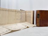 two old books sitting on a table next to each other