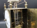 a gold clock that is sitting on a table