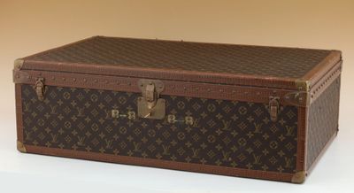 a brown and black suitcase sitting on a white surface