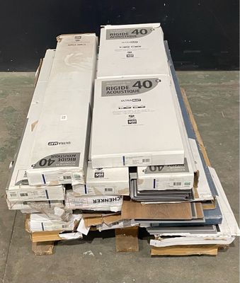 several boxes of electronic equipment are stacked on pallets in a warehouse