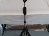 a light that is on a tripod in front of a white backdrop