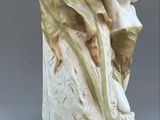 a statue of a woman holding a flower in her hand