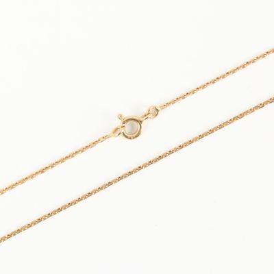 a gold chain with a single pearl on it