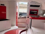 an image of a red and white kitchen in a boat