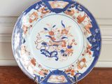 a blue and white plate with a picture of a dragon on it