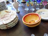 many plates and glasses on a table with a vase