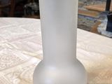 a glass vase sitting on a table in a room
