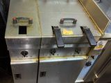 an image of a commercial fryer sitting in a kitchen next to a door