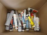 a cardboard box filled with different types of glues