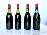 three bottles of wine are lined up on a marble table