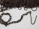a bunch of chains and a hook on a table