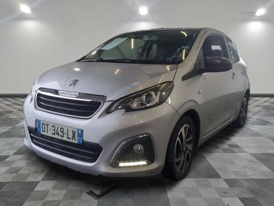 the small silver car is parked in a large room