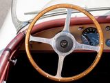 a steering wheel and dashboard of a vintage car