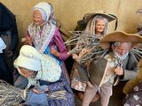 many figurines of people that are sitting on a shelf