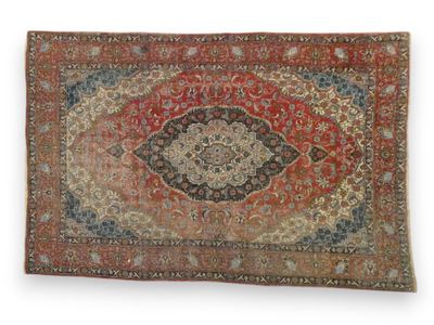 a red and blue rug with a medallion design on it