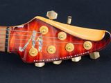 the neck of an electric guitar with a red and yellow neck