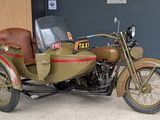 a motorcycle with a side car parked in front of a garage