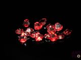some very pretty red diamonds on a black surface