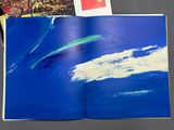 a picture of a book with a picture of a person on a surfboard