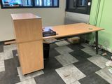 an image of a desk in an office with a lot of clutter on the floor