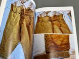 an open book with a picture of a man ' s pants on it