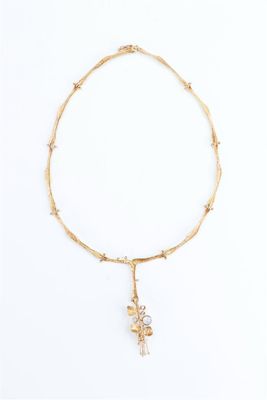 a close up of a necklace on a white surface