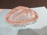 a glass bowl on a table with a blue surface