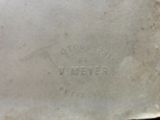 a silver plate with writing on it sitting on a table