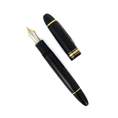 a black pen and a gold trim on a white background