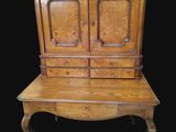 an old wooden cabinet with two drawers on top of it