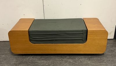 a stack of folded sheets on top of a wooden box
