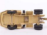 a yellow toy truck with black wheels on a white surface