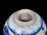 a blue and white vase on a black background