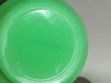 a close up of a green plastic bottle with a lid